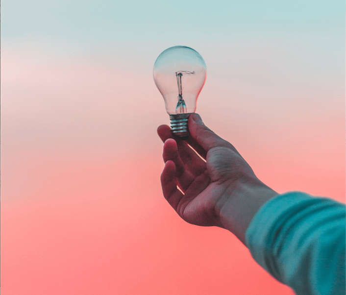 Image of person holding light bulb